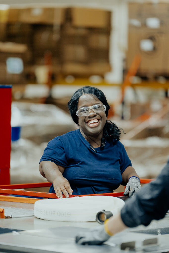 An employee laughing while working on the hose line