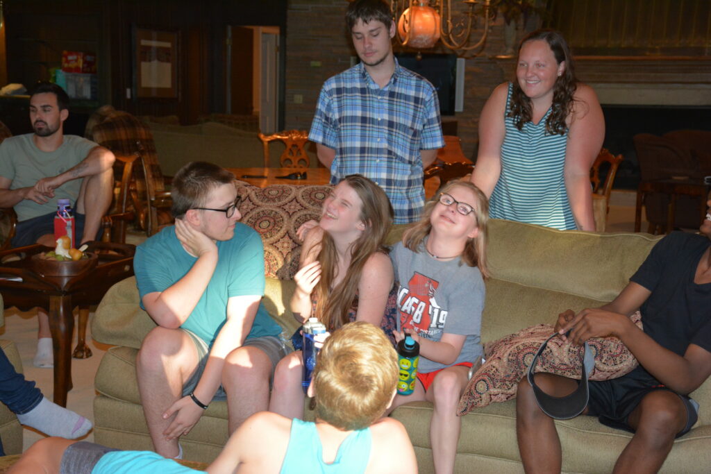 Campers are being silly in their down time back at the camp lodge.