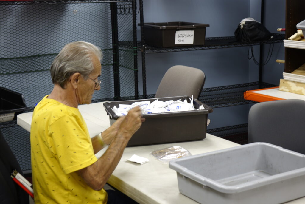 An employee working diligently in the kitting department