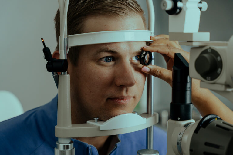 NewView client sits in an eye exam room receiving an exam.