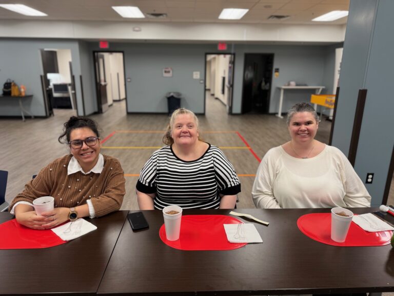 Melissa, Catherine and Hannah all smile for a photo during a VITAL lunch at NewView.