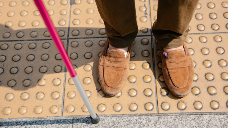 White cane at a cross walk