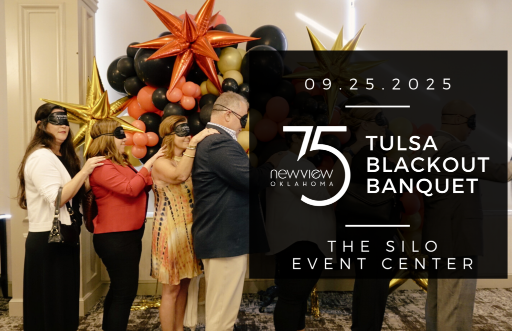 Guests from a previous Blackout Banquet are seen blind folded with their hand on the shoulder of the person in front of them being led to their chairs.