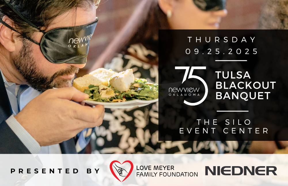 A man is seen blindfolded trying to figure out what food is on his plate while attending a previous blackout banquet hosted by NewView. 