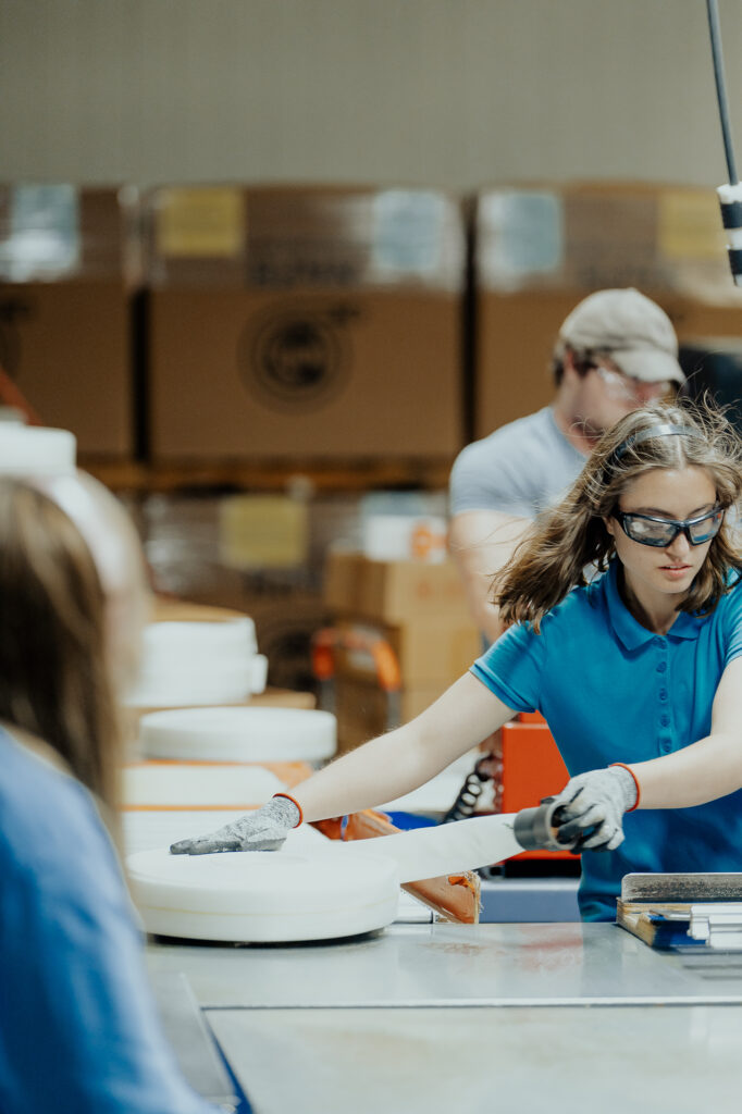 A NewView employee is seen preparing to package hoses manufactured at NewView.