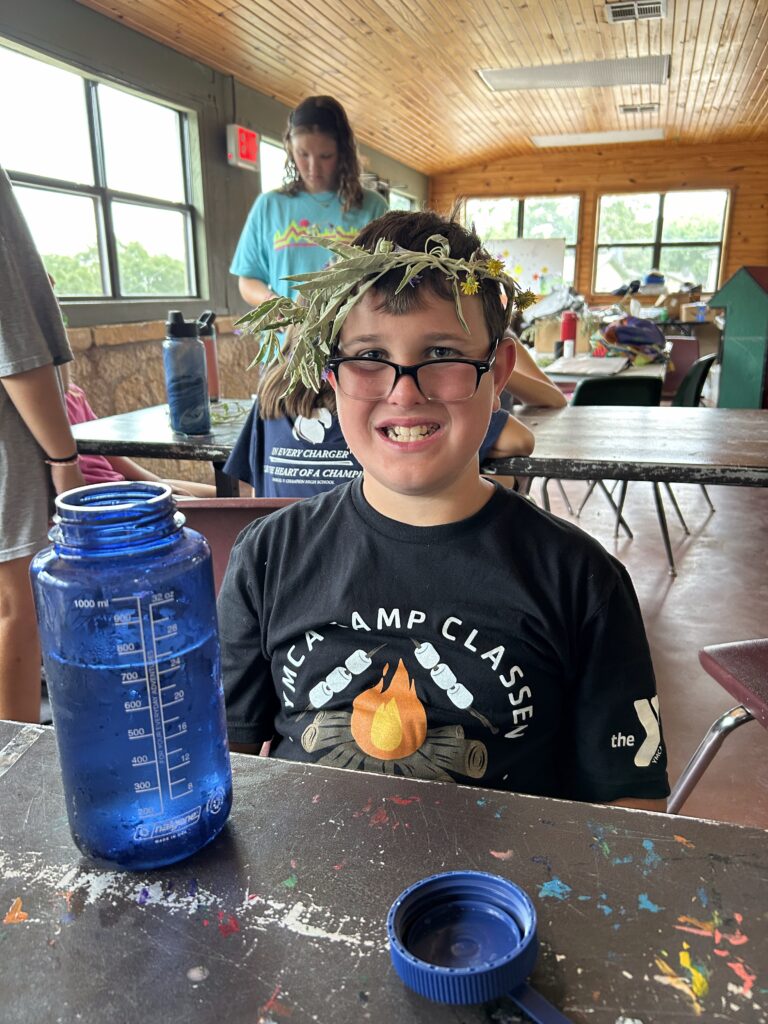 A camper with a funny weed flower crown.