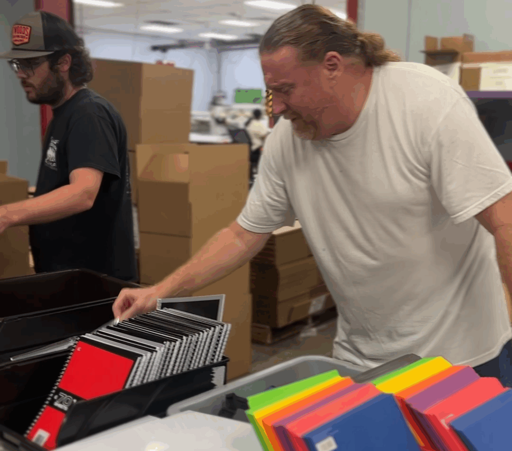 NVO employees putting together school supply filled backpacks