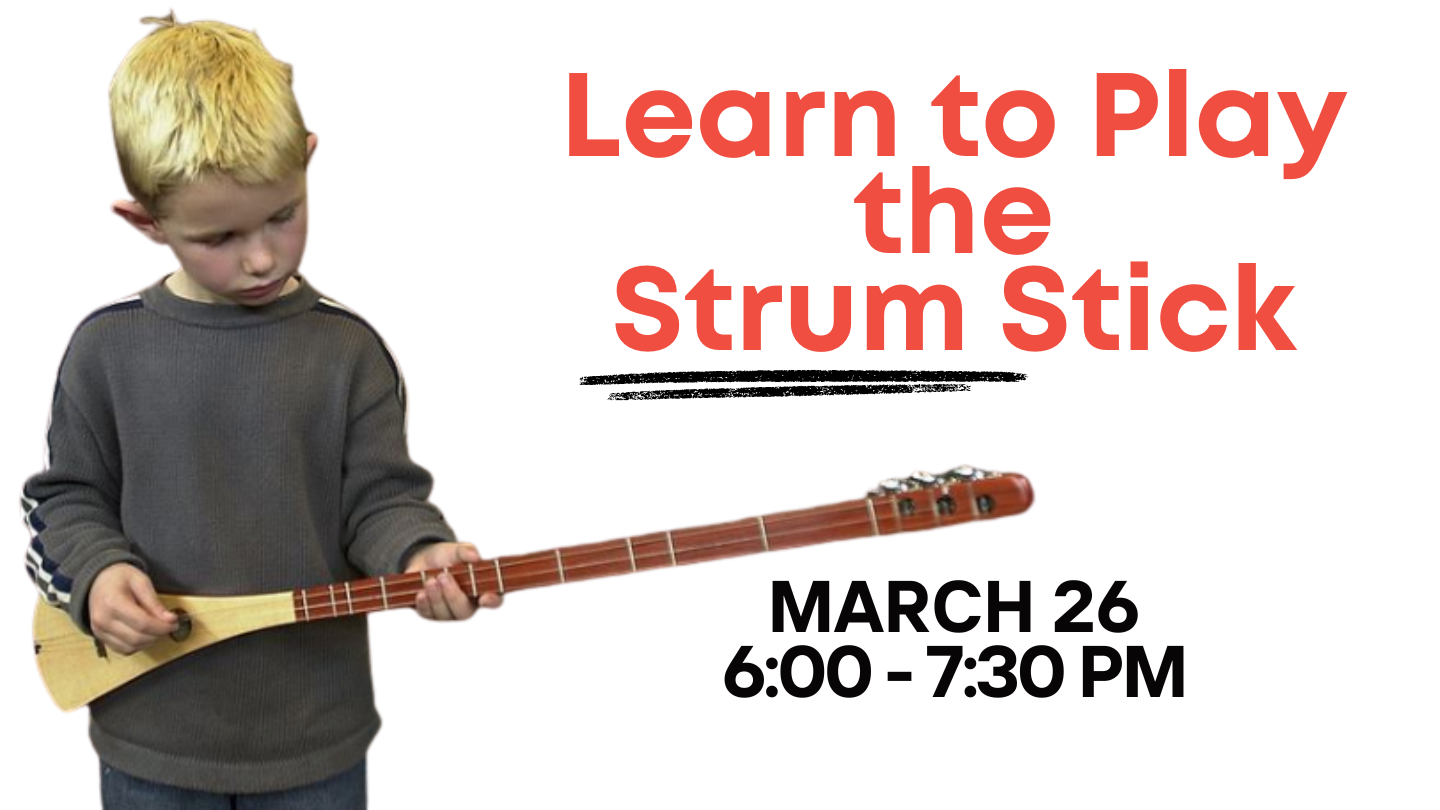 Little boy playing the strum stick.