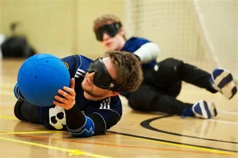 two blind volleyball players with eye masks on