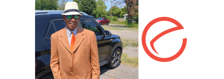 Karl in a fancy suit with NVO logo next to him.