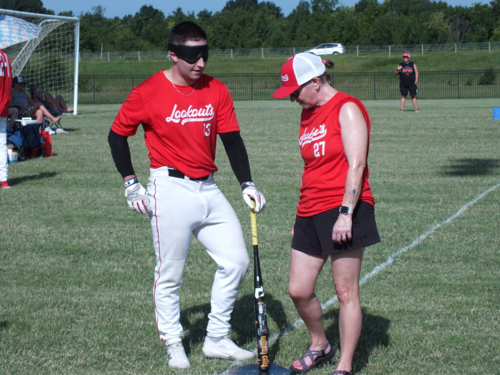 Oklahoma Lookouts Connor and "Team Mom" Melissa standing next to homebase.