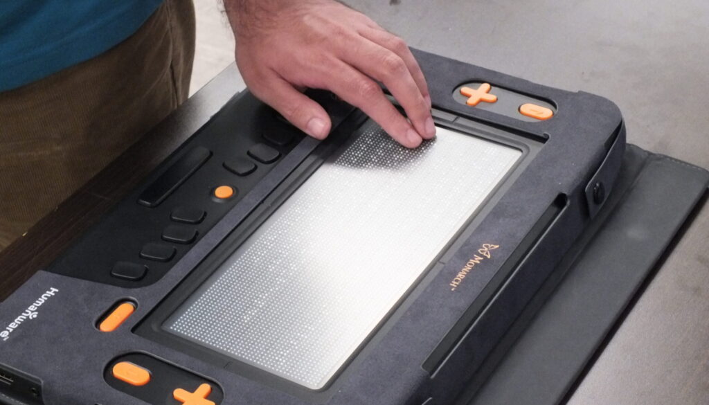 A NewView VR student trying out a new braille reader.