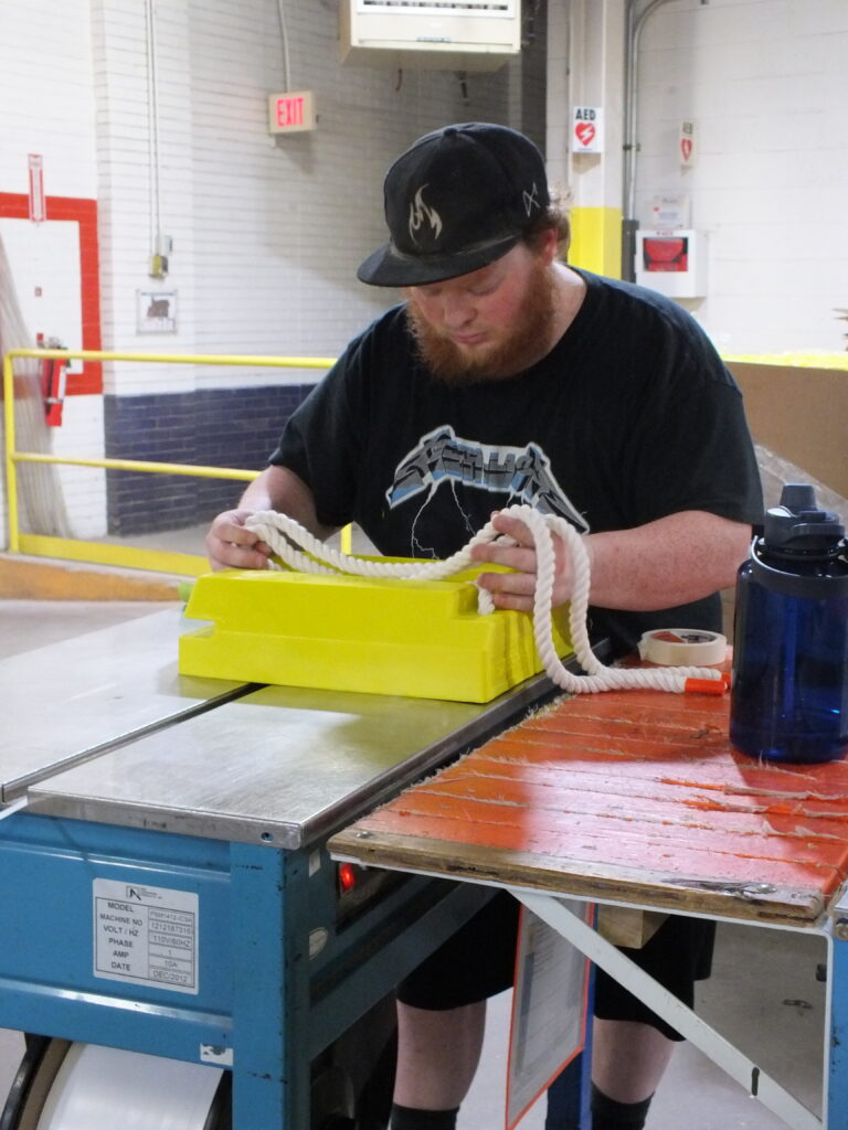 Man with baseball that putting together wheel chocks.