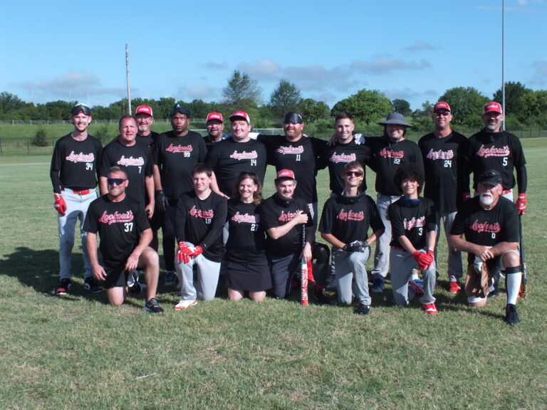 The NewView Oklahoma Lookouts beep baseball team poses together on the field in matching black jerseys at the 2026 Sooner State Classic.