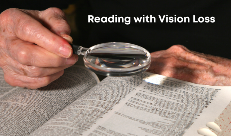 hand holding a magnifying glass over a book with the words "reading with vision loss" on a black background.