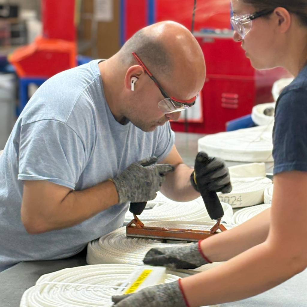 Donald in Douglas Plant working hard at Hose Station alongside coworkers. 